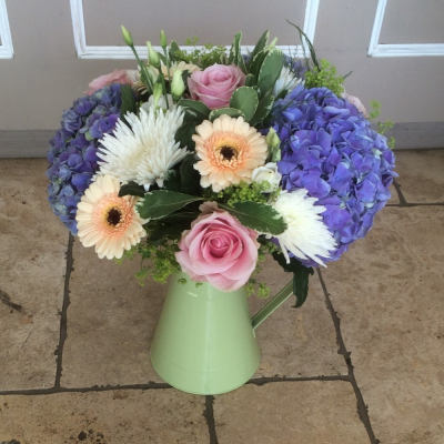 Arrangement in Zinc Container - Flower content and colours may vary from example images.

Zinc Jug colour varies upon availability.

Florists choice of colours and flowers but can be made with custom colours please add this into the special instructions

Expertly arranged in a handtied style, to